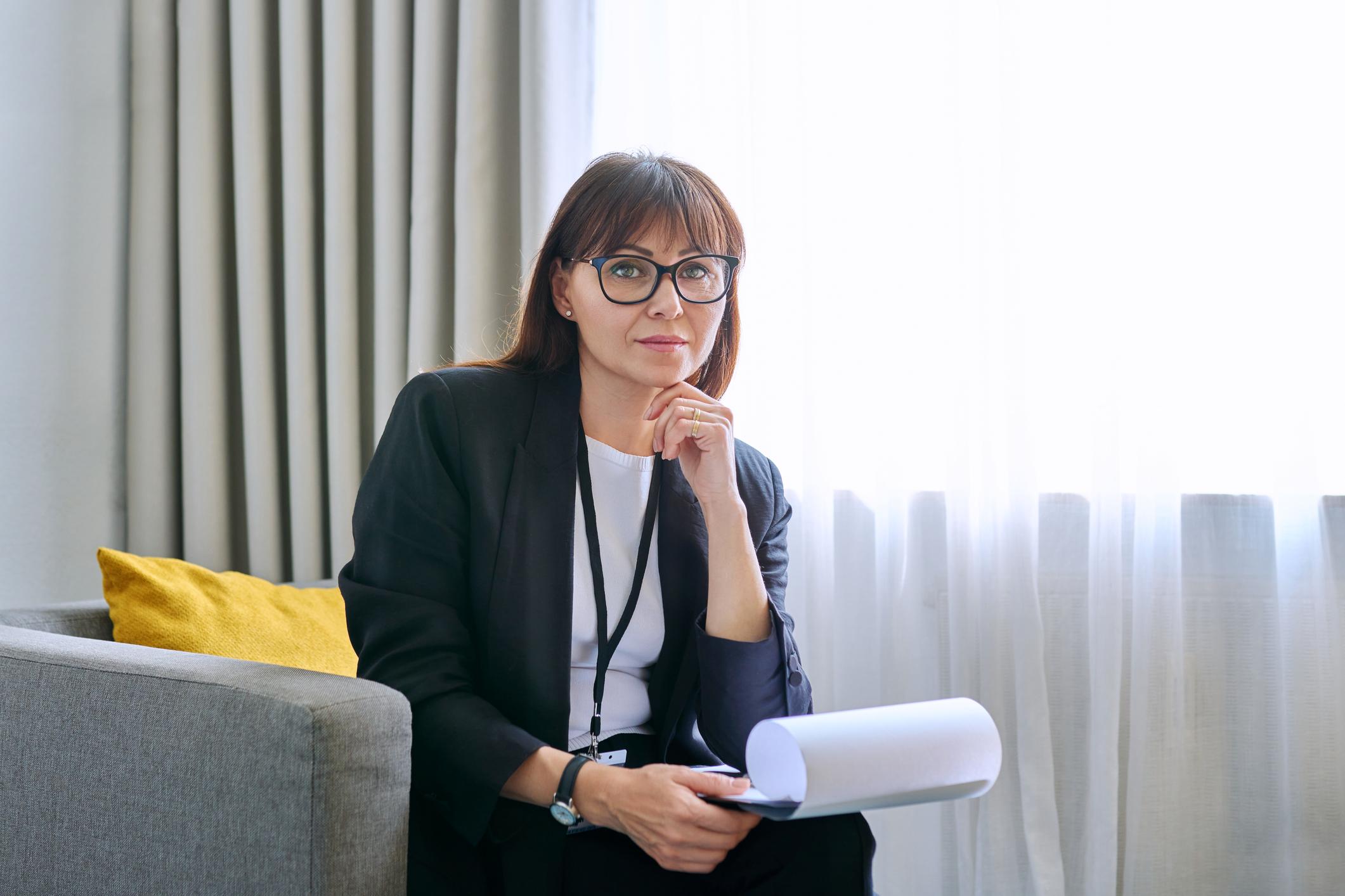 woman holding clipboard looking at camera